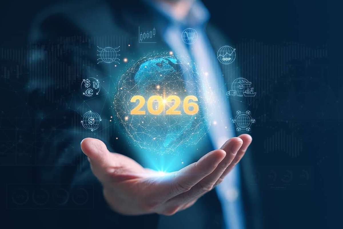 A digital graphic of the year 2026 surrounded by icons above a man's hand.