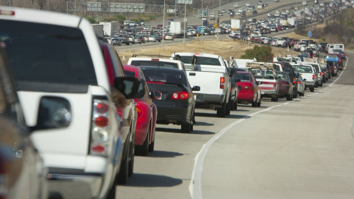 A freeway with backed up traffic.