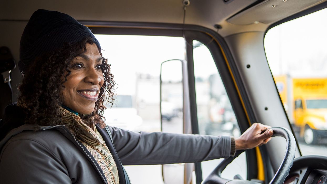 A happy truck driver behind the wheel