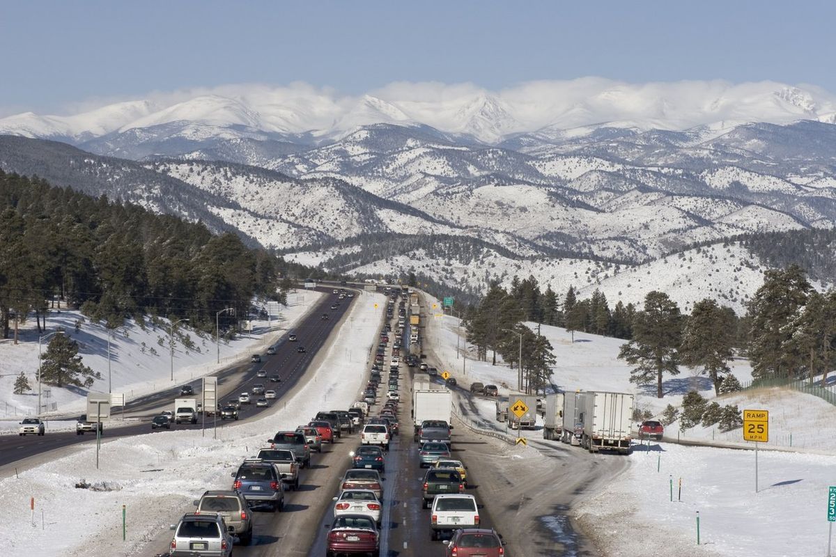 A holiday traffic jam in front of snowy mountains.