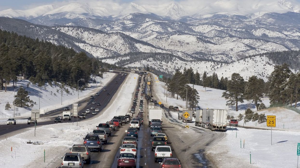 A holiday traffic jam in front of snowy mountains.