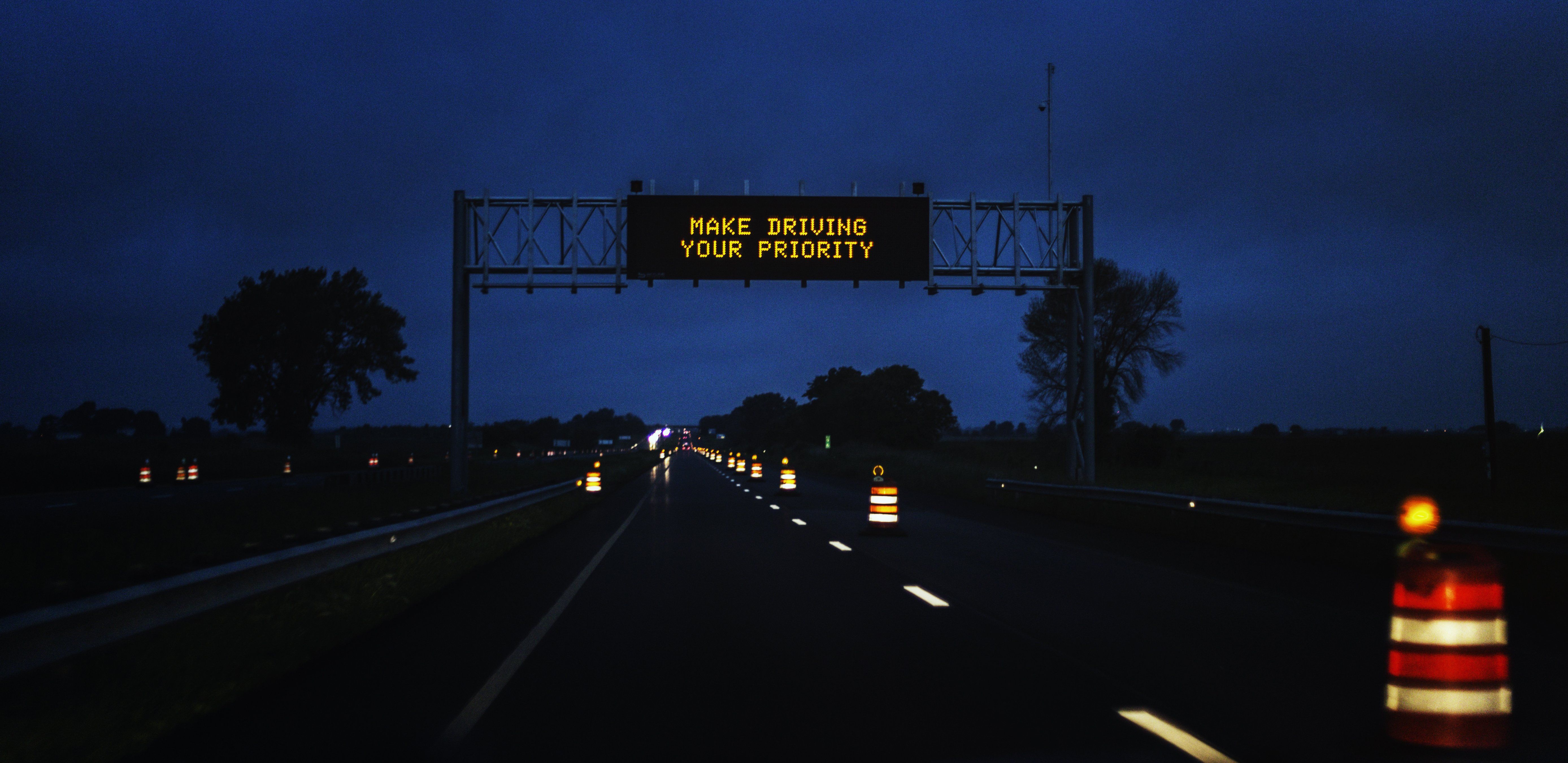 A Make Driving a Priority highway sign