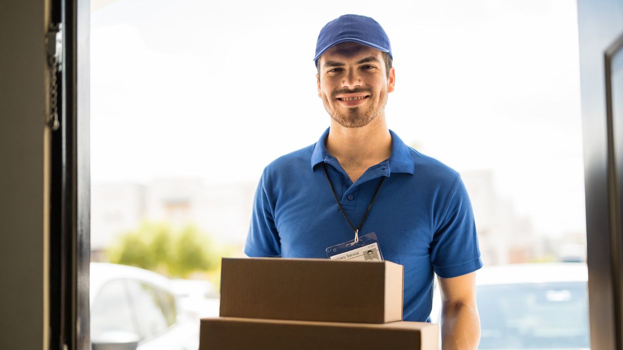 A man delivers boxes to a business.