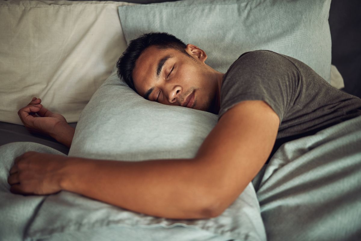 A man sleeping on a grey pillow