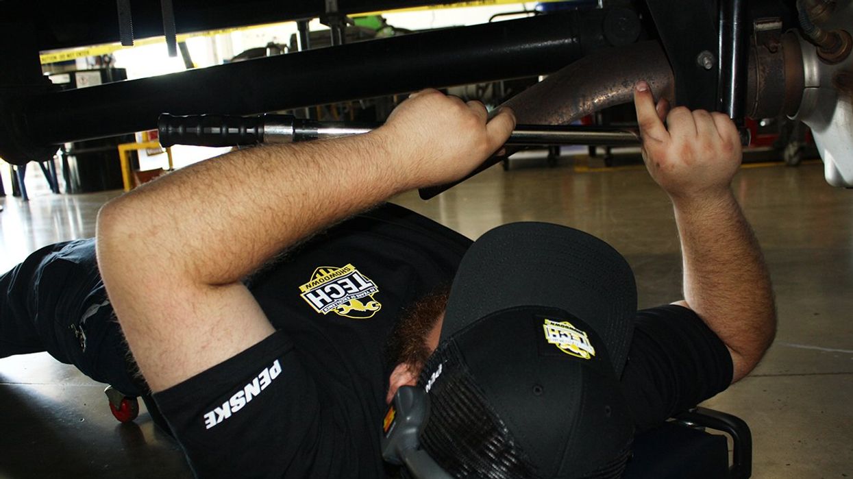 A Penske technician performs a hands-on inspection as part of the 2025 Tech Showdown competition.