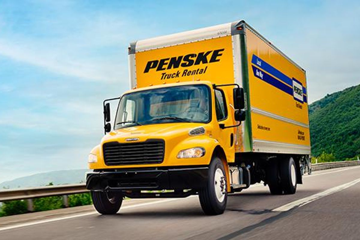 A Penske truck driving on the road