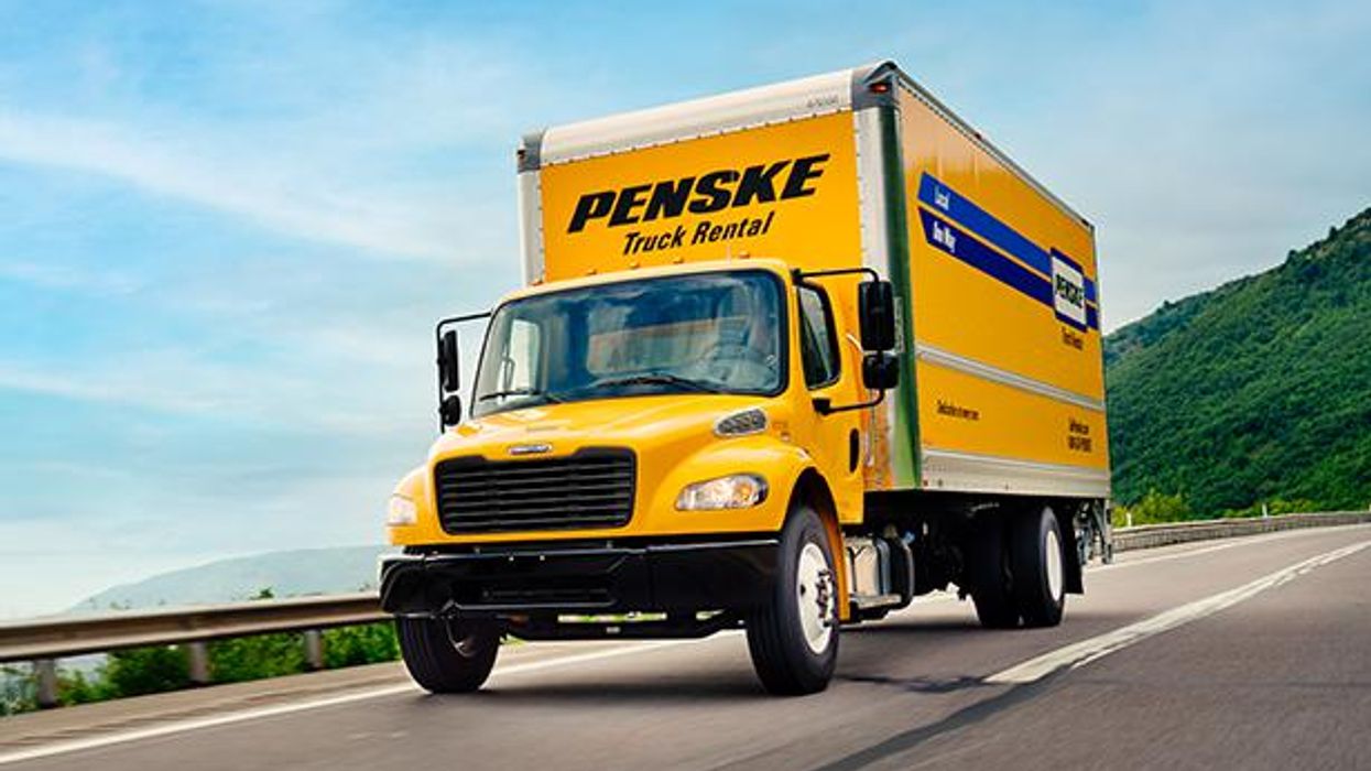 A Penske truck driving on the road