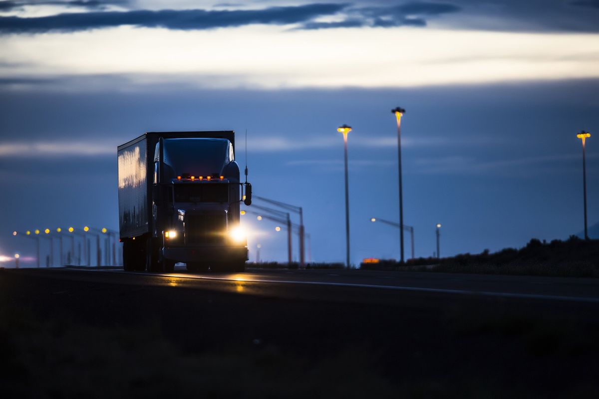 A semi-truck driving at night