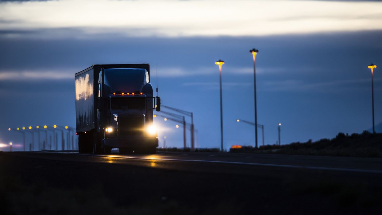A semi-truck driving at night