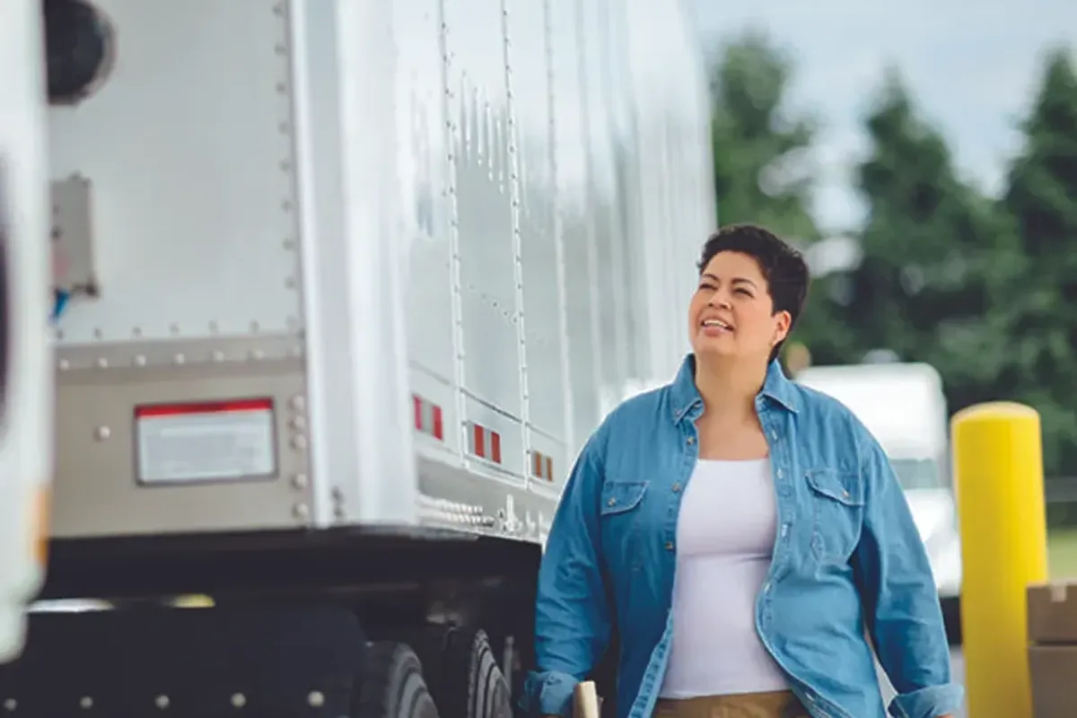 A truck driver conducts a vehicle inspection