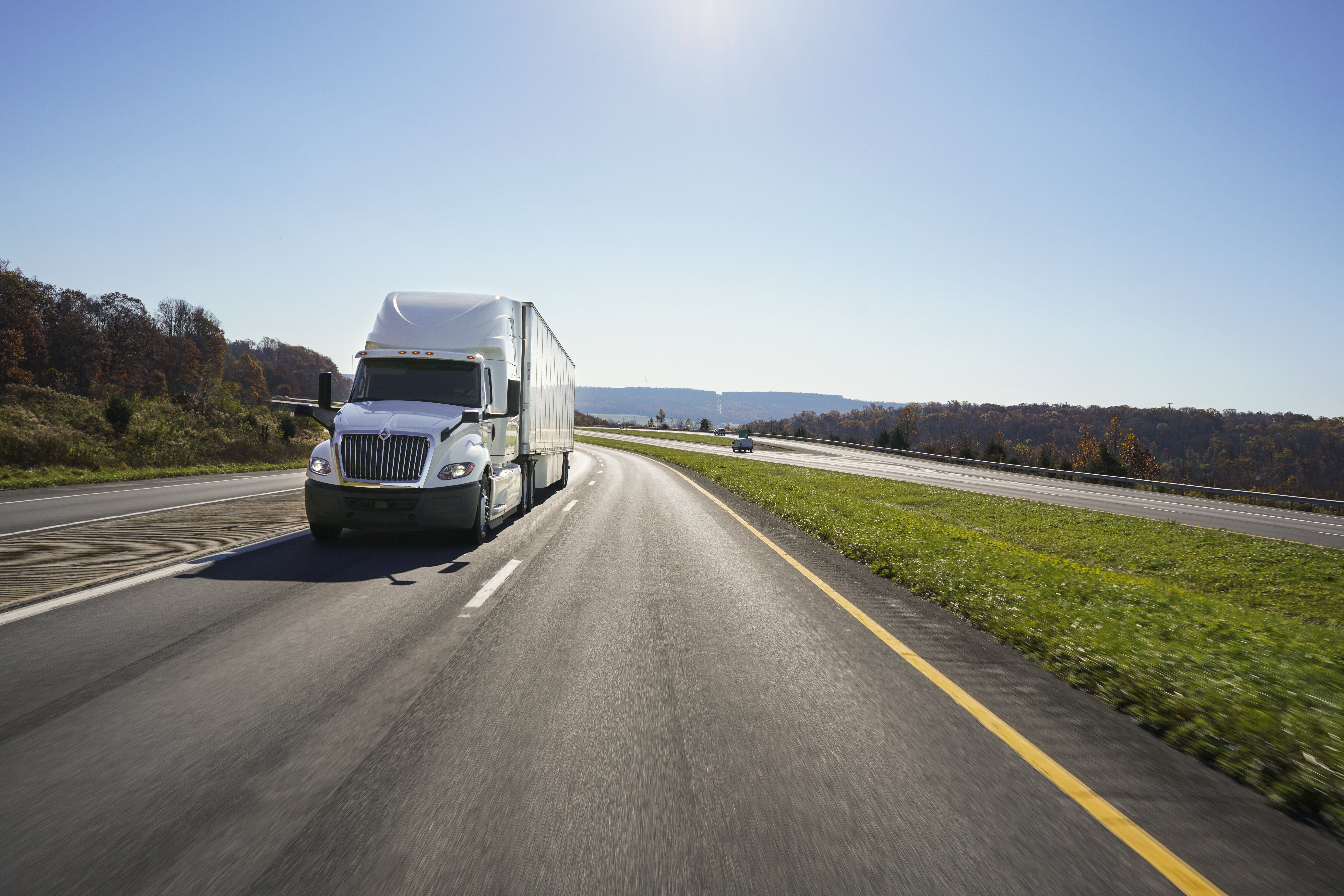 A white Penske semi on the road