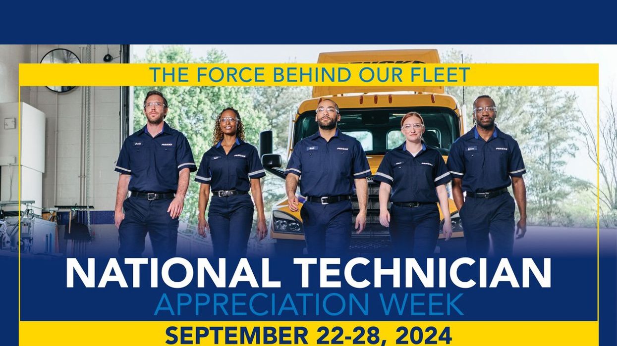 Associates walking in front of parked Penske truck.