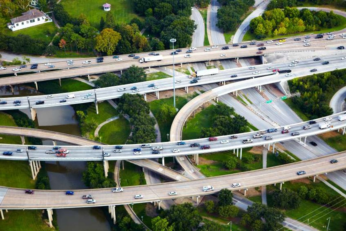 Cars driving on raised highways in the suburbs.