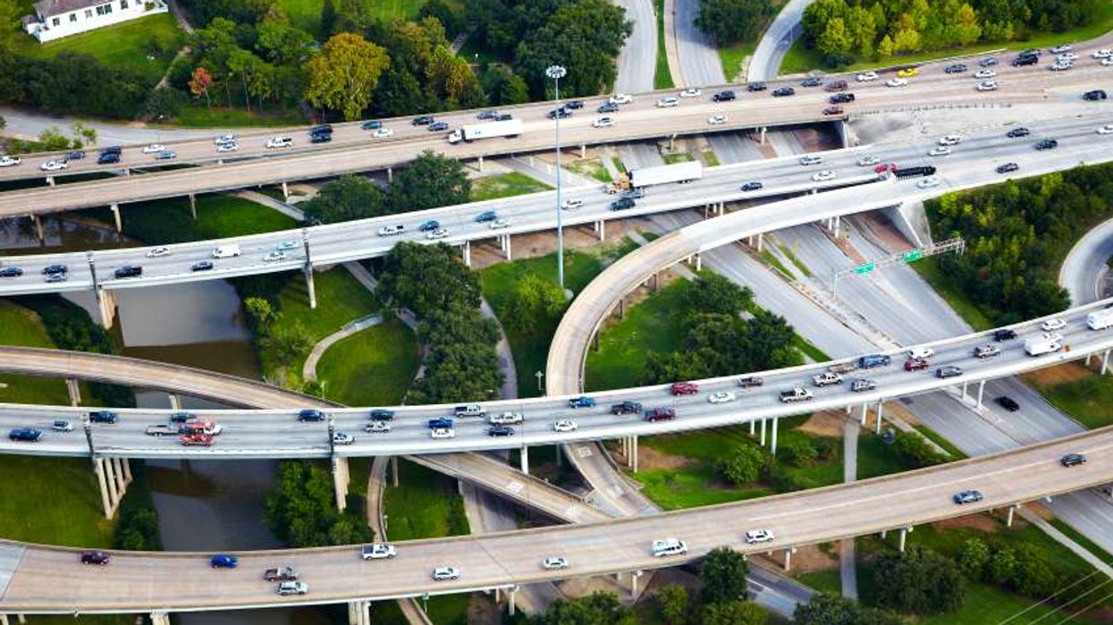 Cars driving on raised highways in the suburbs.