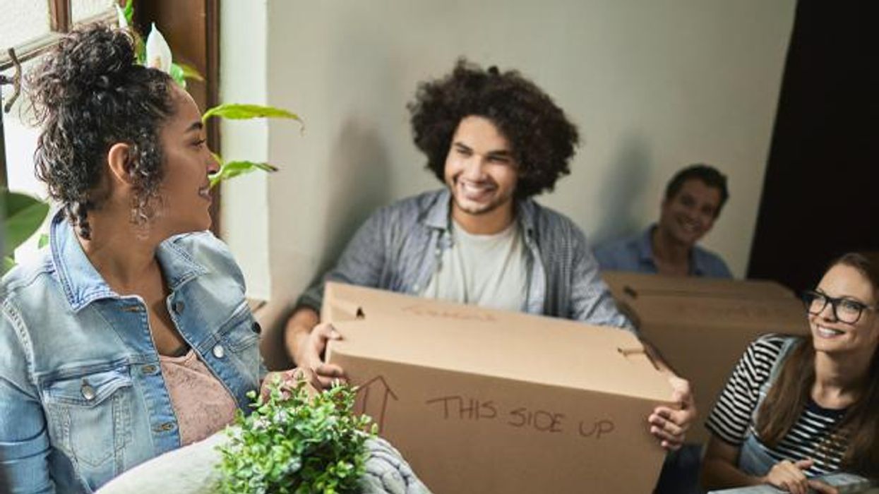 College students carry moving boxes.