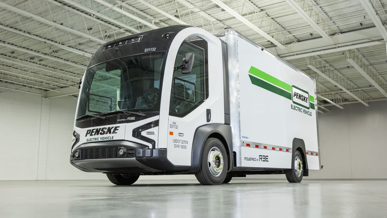 Electric truck from REE Automotive Ltd. sitting on a showroom floor.