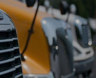 Front grills of trucks lined up