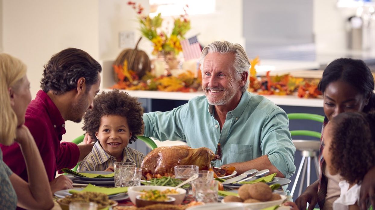 Family gathered around the table for Thanksgiving dinner.