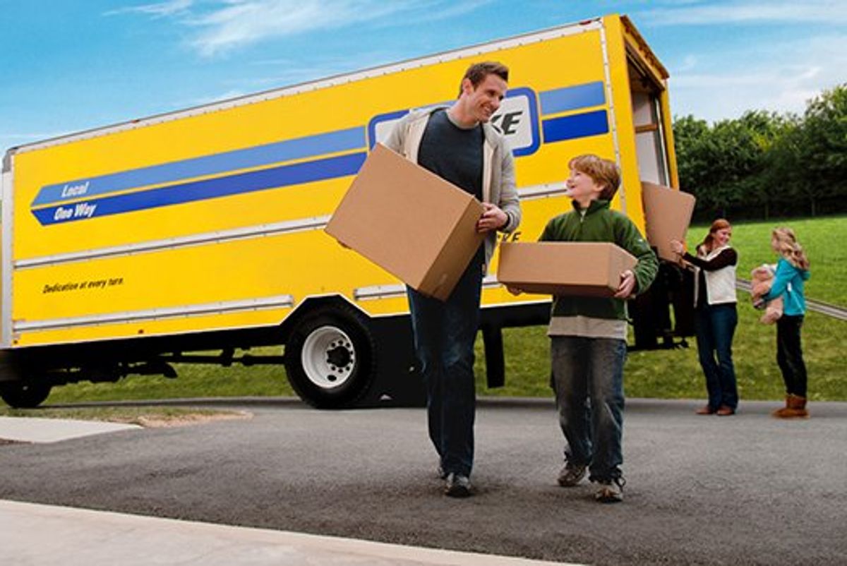 Family unloading boxes from a moving truck.