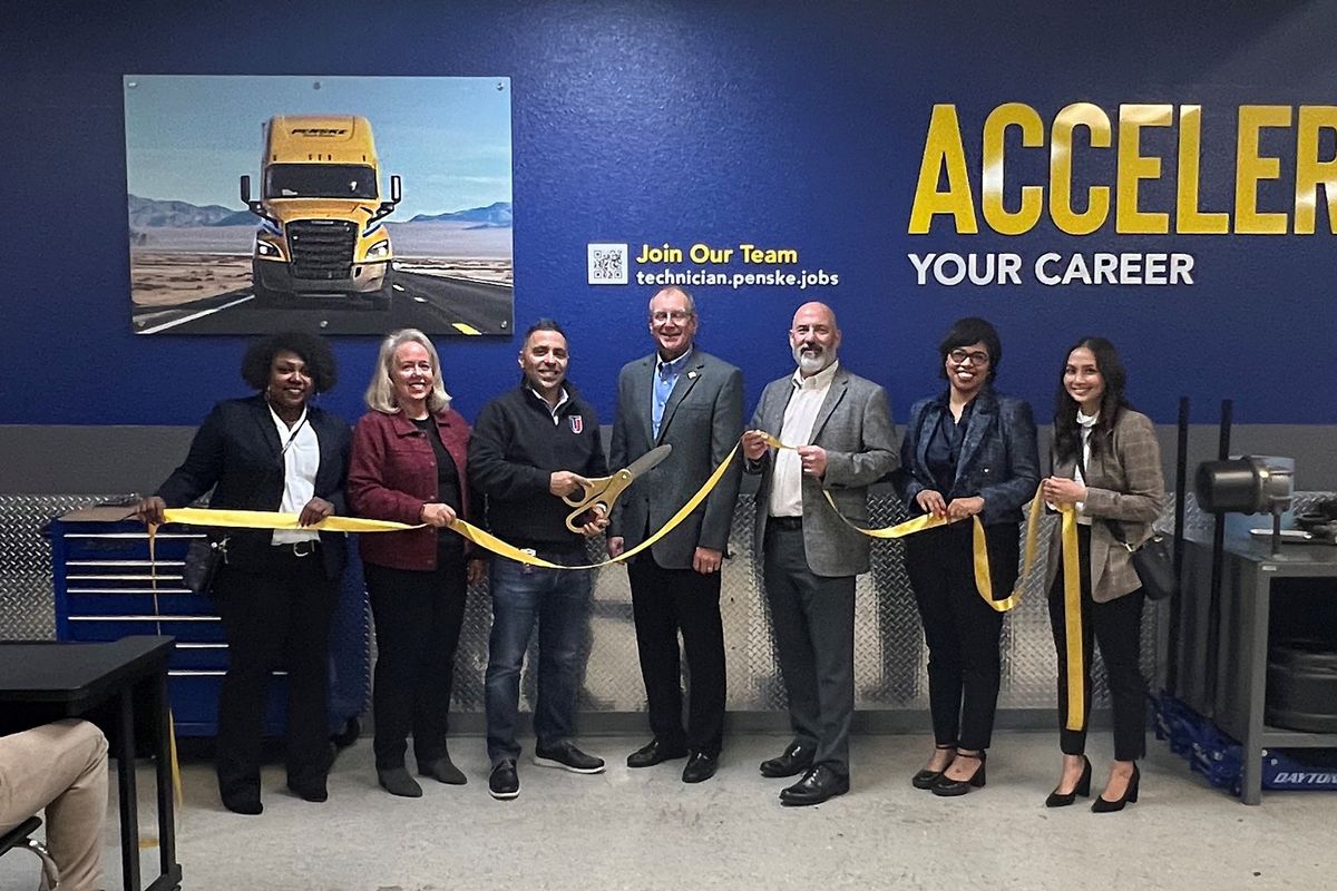 Group of people at a ribbon-cutting event.