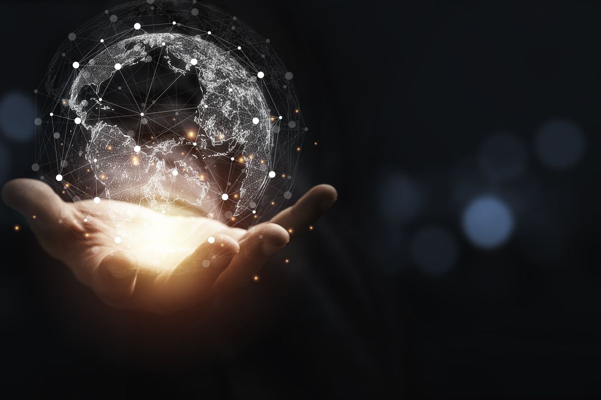 Hand holding a graphic representation of a globe.