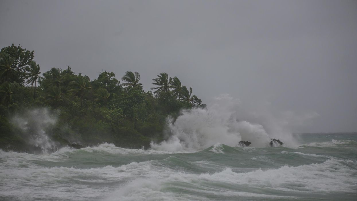 High tides crash on a tropical shore during a hurricane.