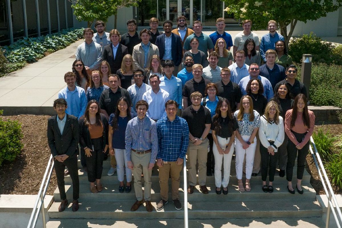 Interns stand outside the company headquarters on the stairs in Green Hills, Pennsylvania.