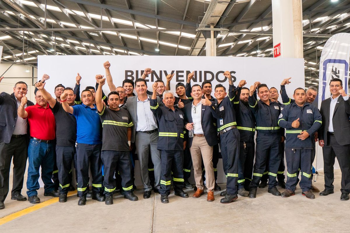 Large group of people celebrating the opening of a new facility.