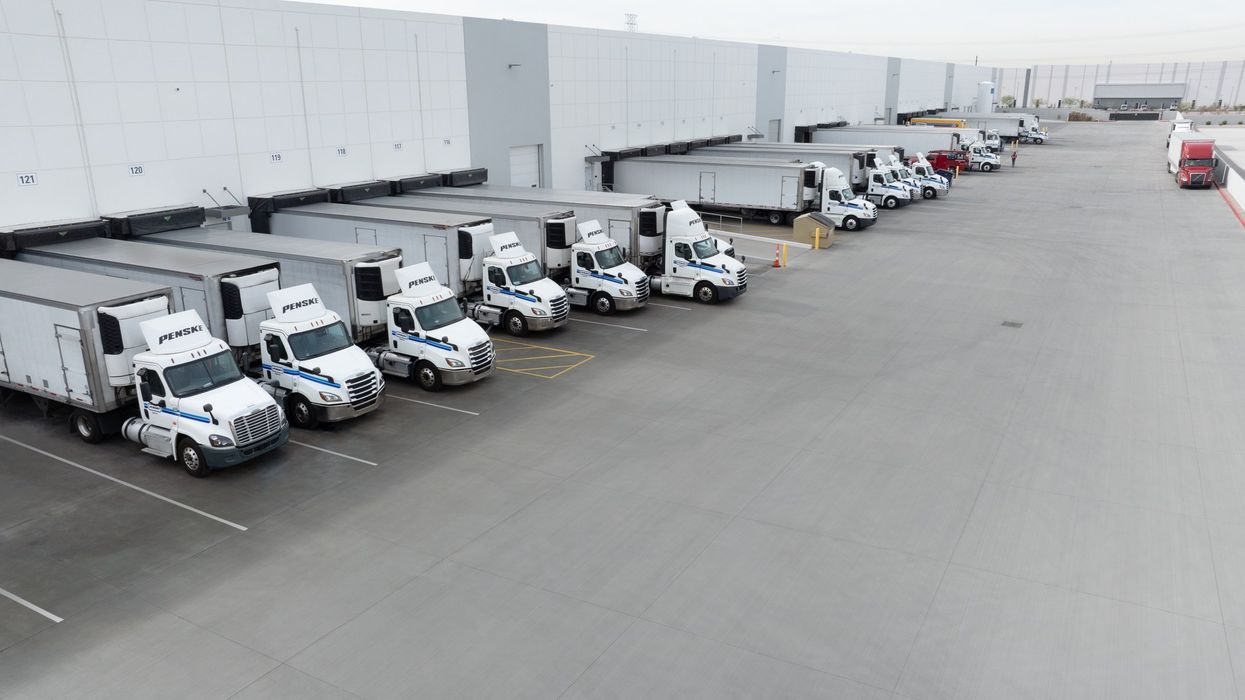 Line of tractor trailers backed up at warehouse docks