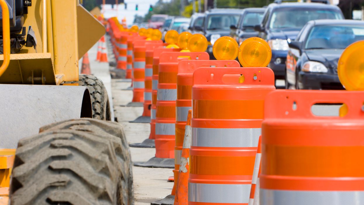 Orange cones marking a work zone on the street.