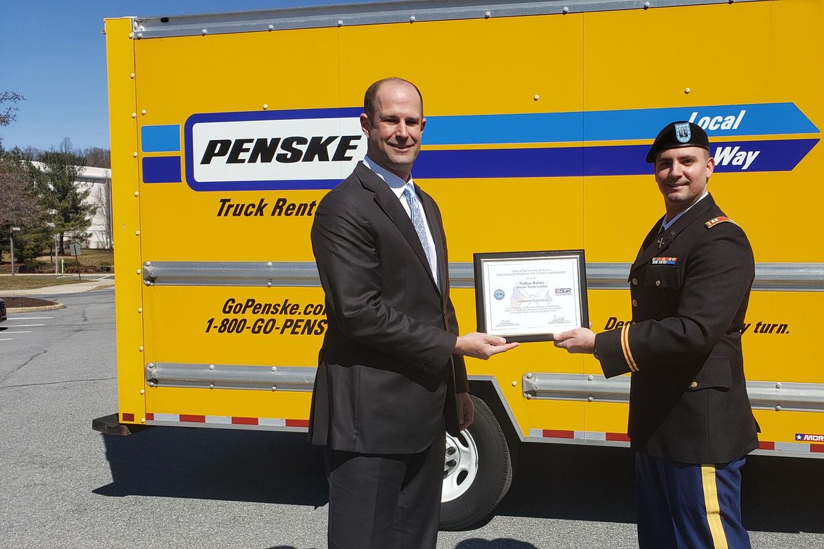 patriot award given in front of penske truck