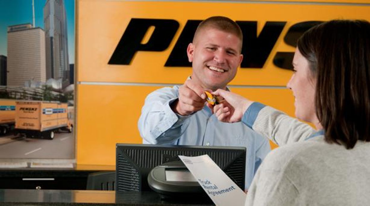 Penske associate behind the rental counter assisting a customer