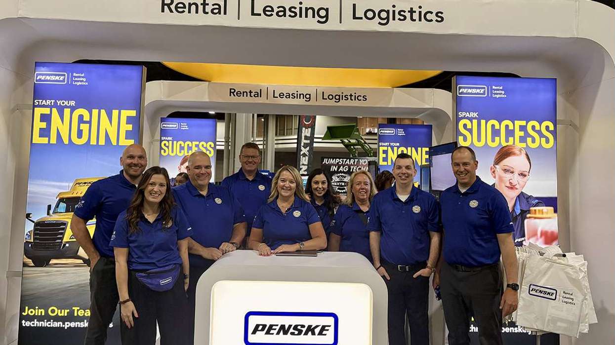 Penske associates standing at SkillSUSA booth