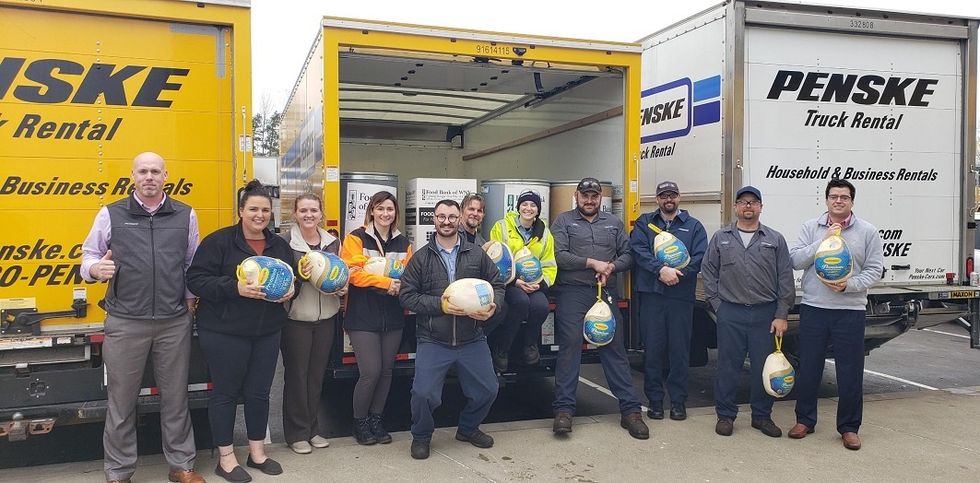 Penske employees with food donations