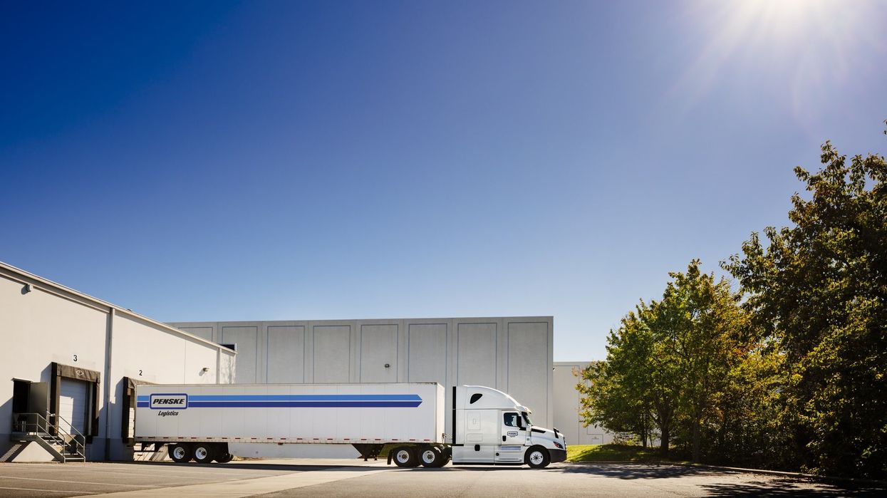 Penske Logistics tractor-trailer backed up to a loading dock.