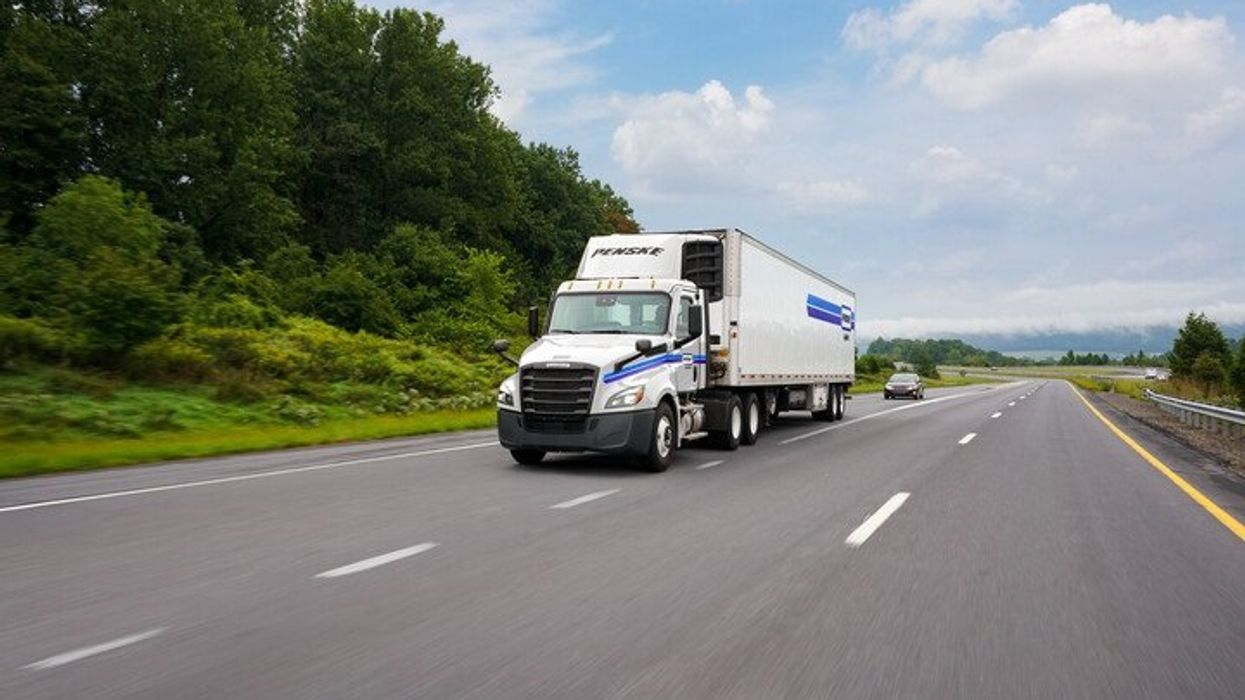 Penske Logistics tractor-trailer driving down the highway.