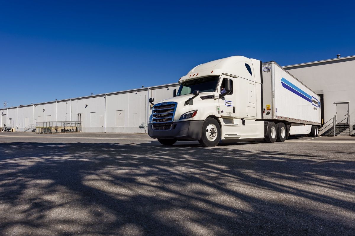 Penske Logistics truck backed up to a loading dock.
