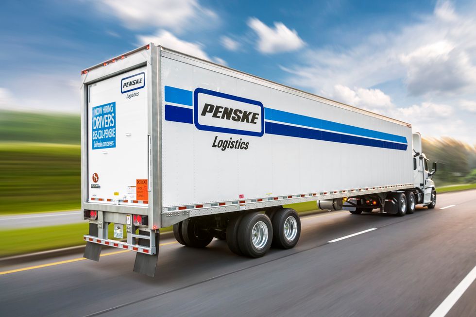 Penske logistics truck driving on the highway.
