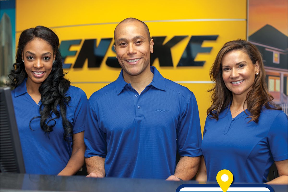 Penske Rental Associates Standing at Rental Counter