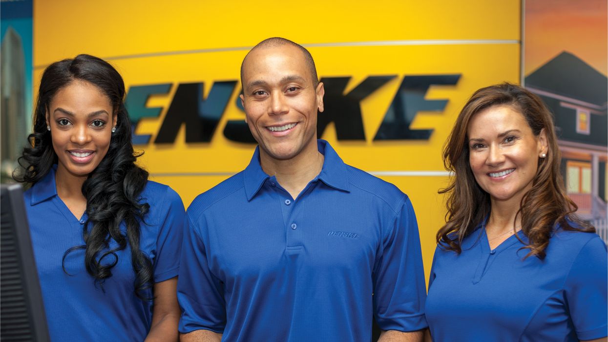Penske Rental Associates Standing at Rental Counter
