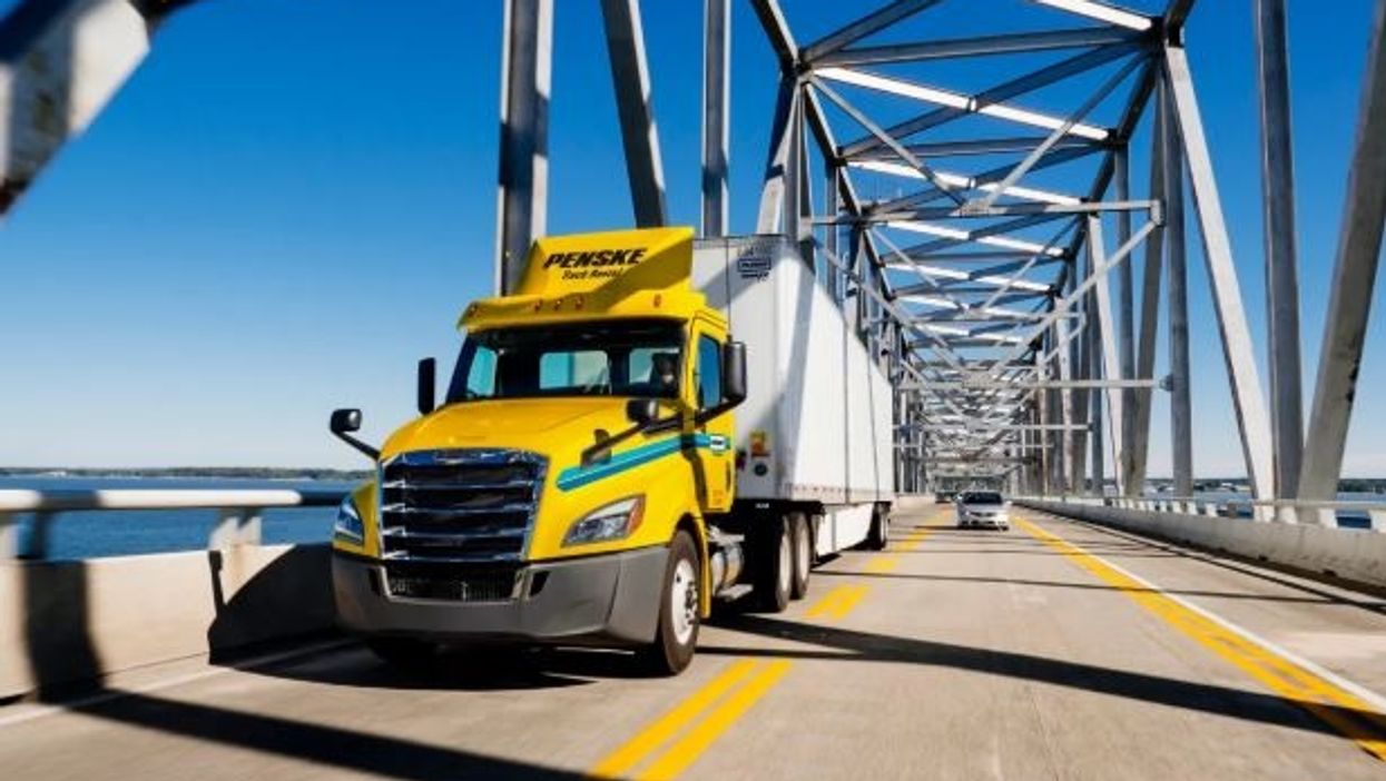 Penske tractor driving over bridge