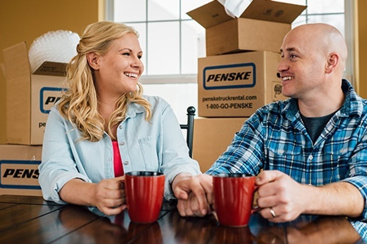 people with penske moving boxes