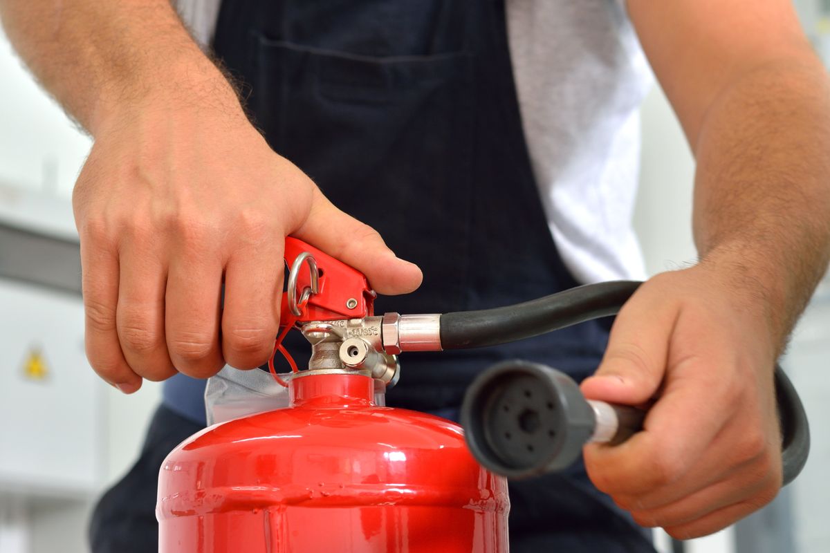 person holding a fire extinguisher