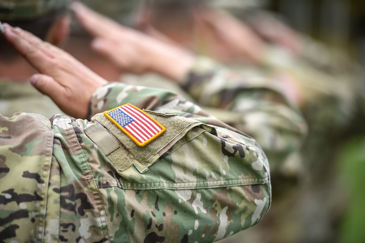 Photo of military service members saluting