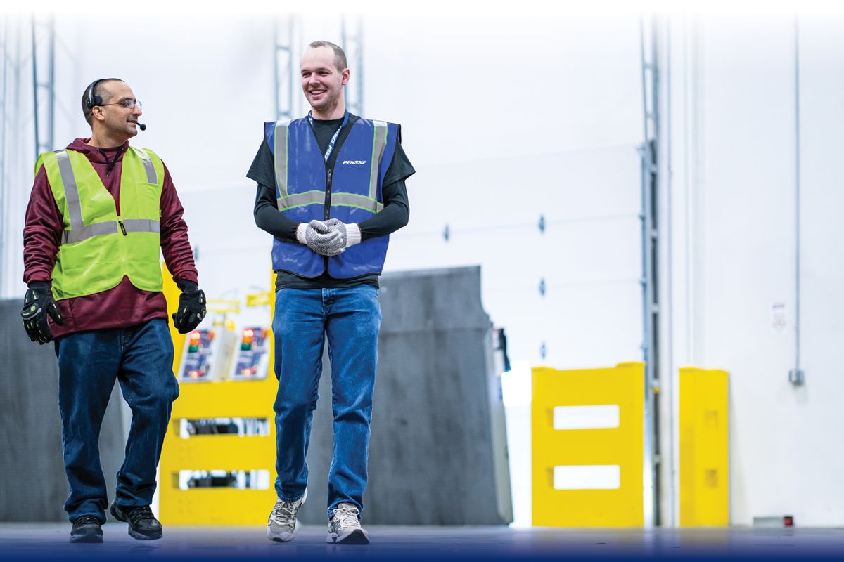 Photo of two warehouse associates walking.