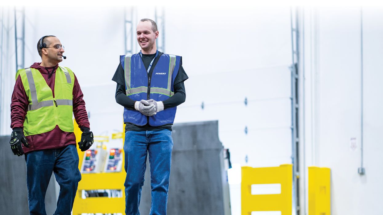 Photo of two warehouse associates walking.