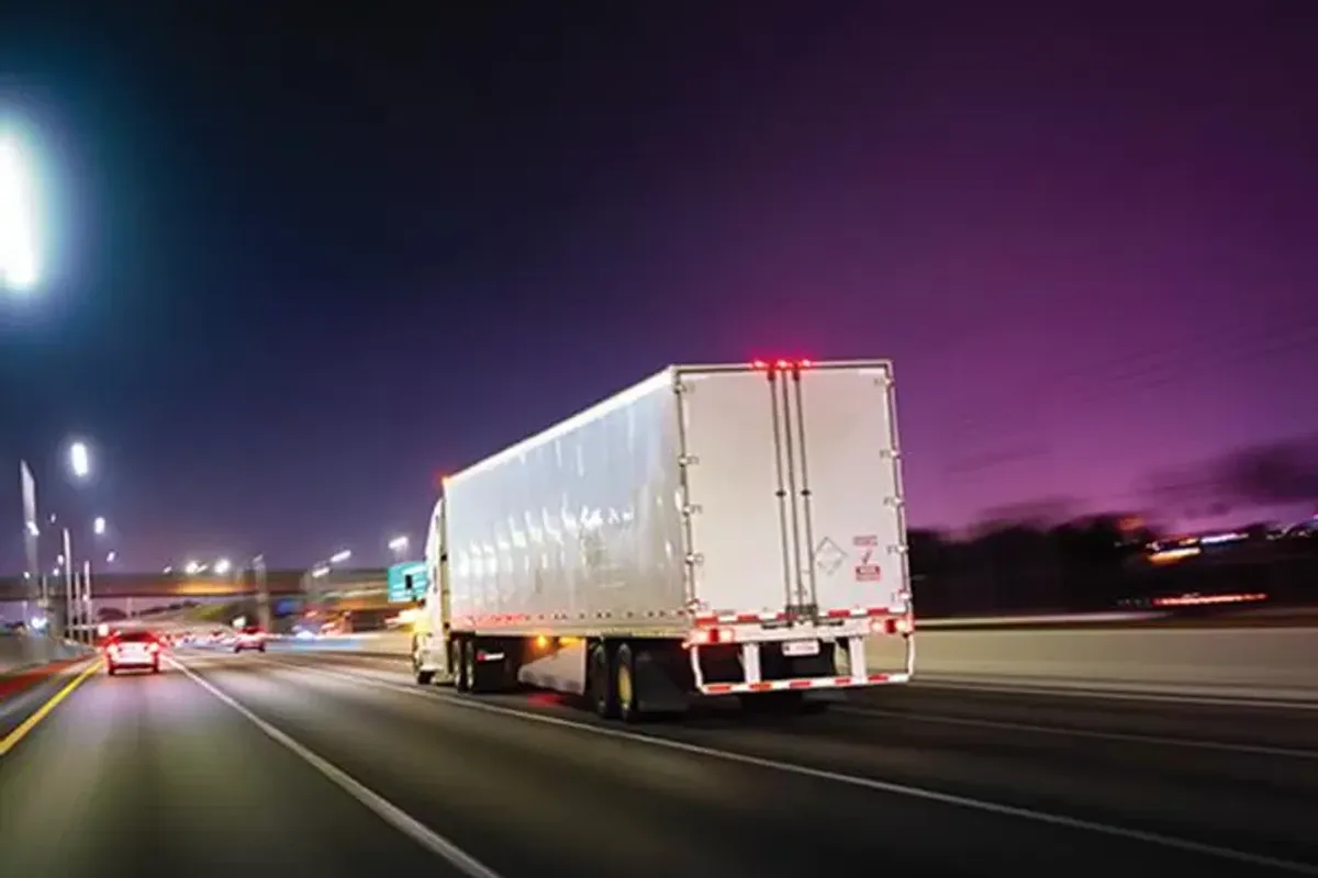 Semi-truck driving at night. 