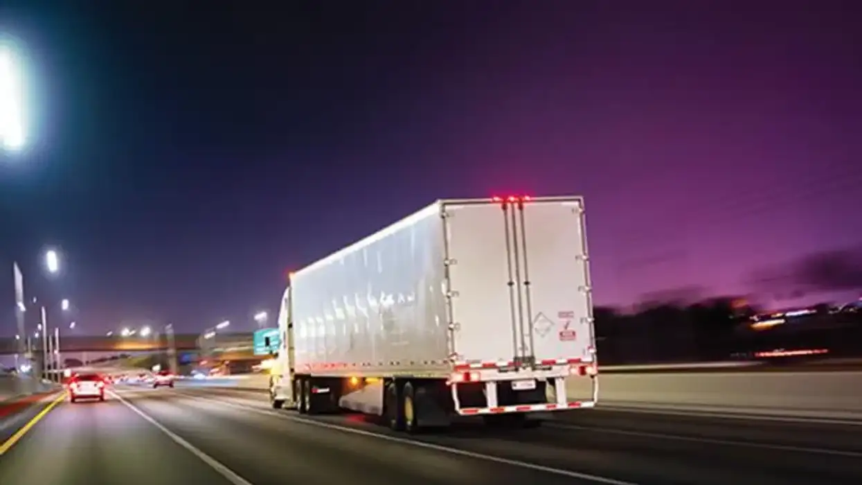 Semi-truck driving at night.