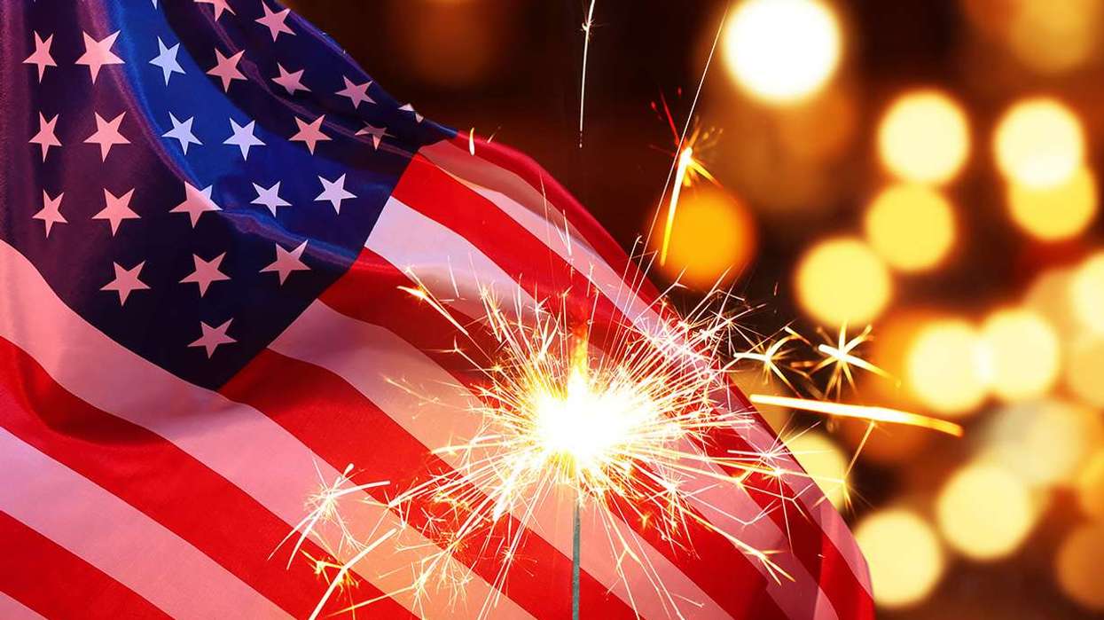 Sparkler with an American Flag in the Background