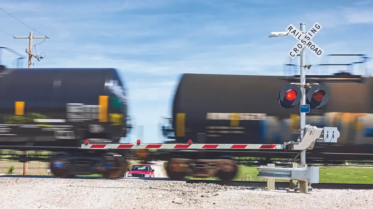 Train speeding by a truck